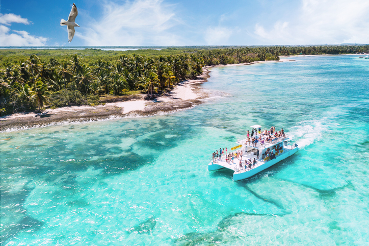 aerial view of a boat on excursion from La Romana to Saona via Punta Cana heading along beautiful caribbean beaches, Dominican Republic